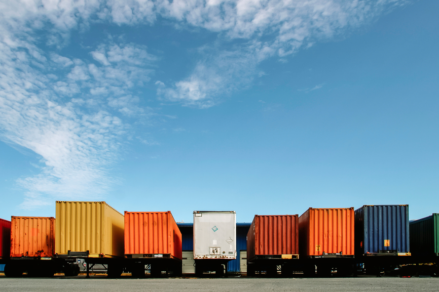 Stock Photo of Shipping Containers lined up at Warehouse distribution facility